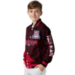 personalized-arizona-wildcats-hexagon-mesh-red-black-varsity-jacket-best-selling.webp