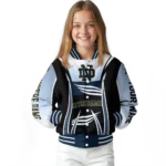 personalized-notre-dame-fighting-irish-mesh-effect-navy-black-varsity-jacket-best-selling.webp